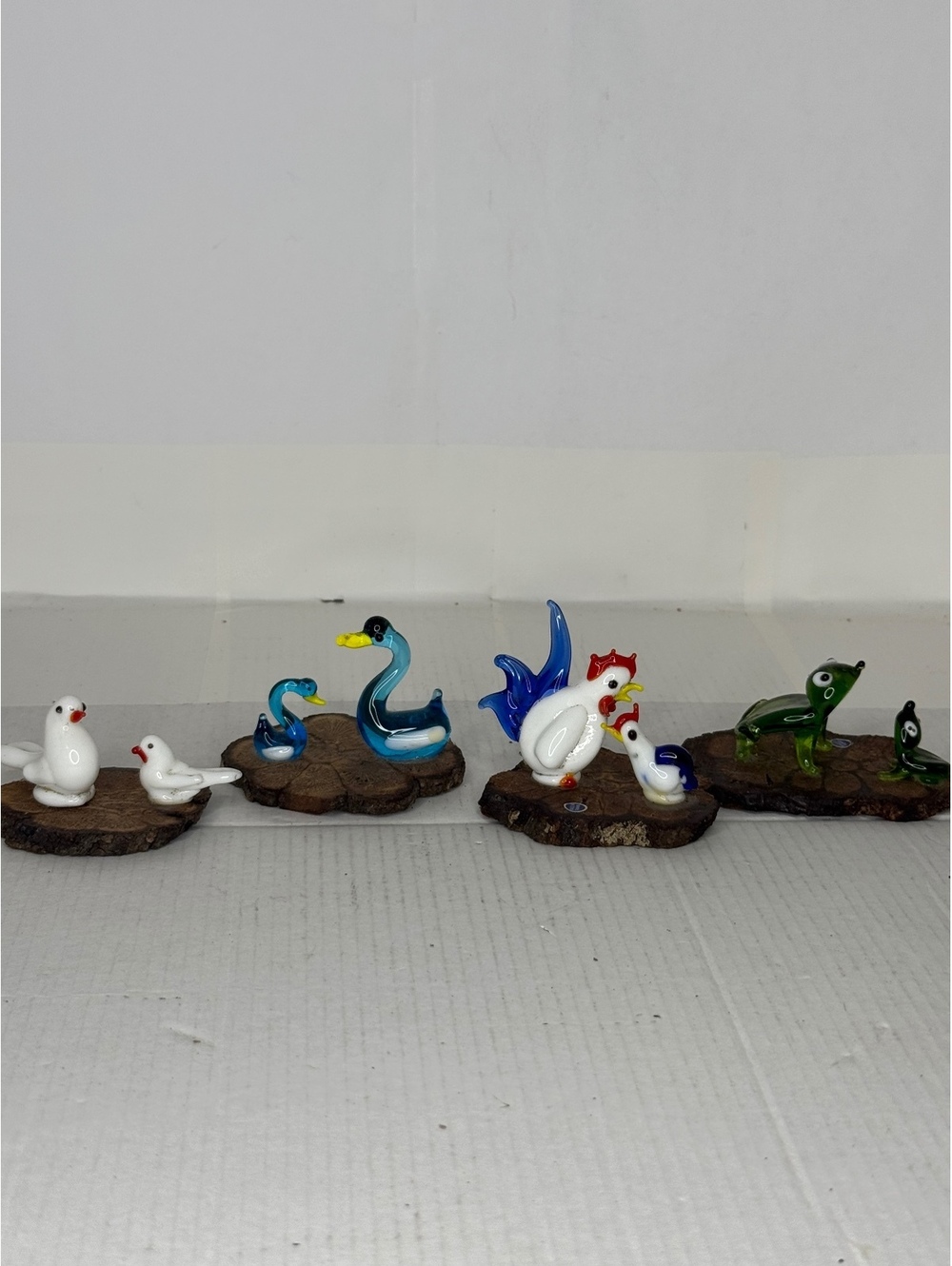 Set of 4 small glass animal figurines on wood bases